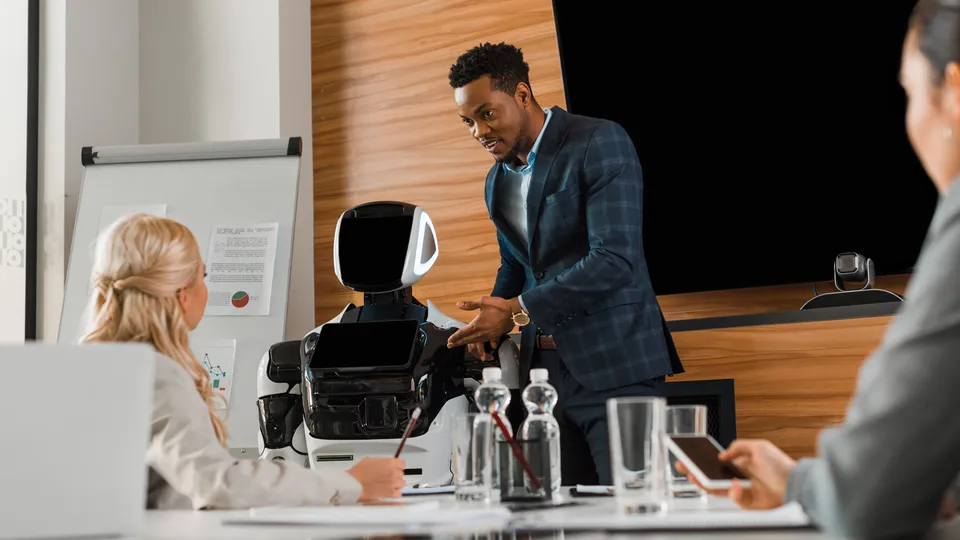 Illustrative photo: Presenter demonstrating a robot to colleagues.