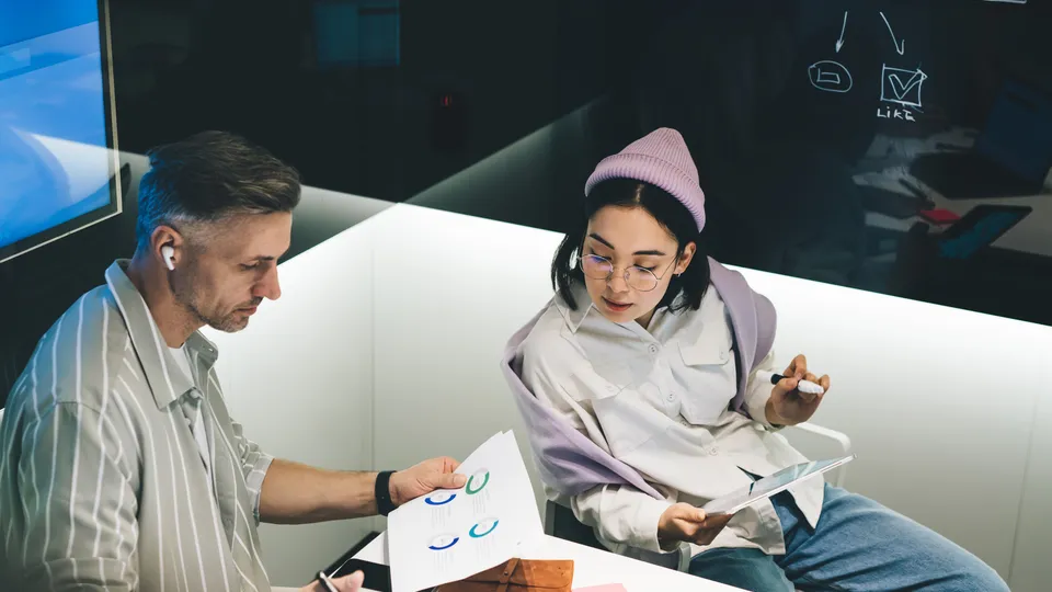 Illustrative photo: Colleagues discussing a project in an office.
