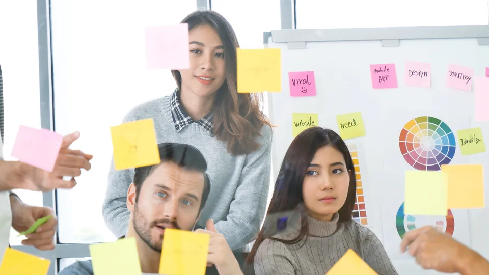 Illustrative photo: Team arranging coloured notes during a workshop.