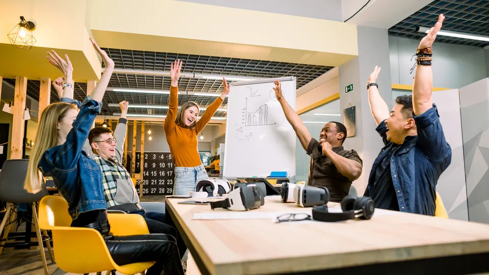 Illustrative photo: Colleagues celebrating together in an office.