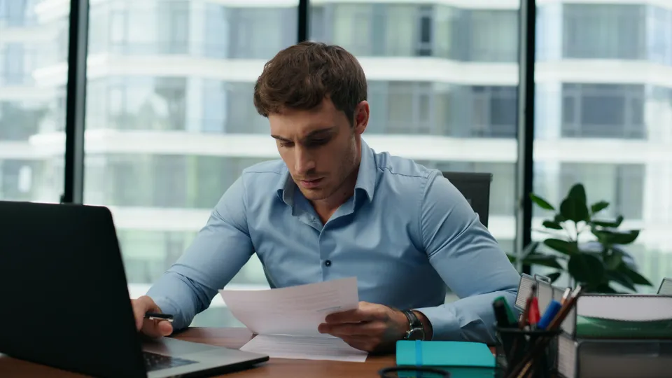 Illustrative photo: Man working at a desk in an office.