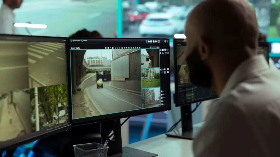 Illustrative photo: Operator reviewing multiple surveillance camera feeds.