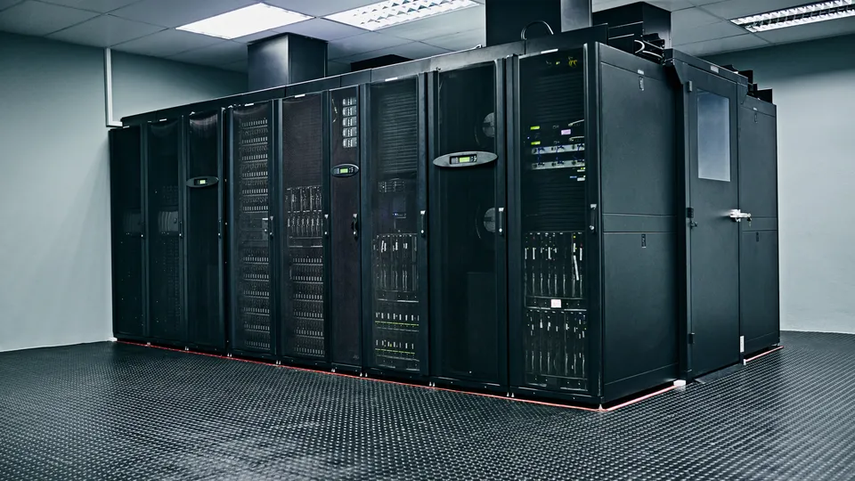 Illustrative photo: Rows of enclosed server cabinets in a data center.