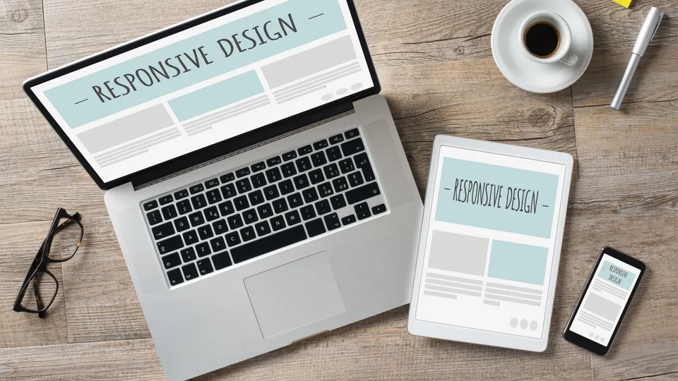 Illustrative photo: Laptop, tablet and phone displaying responsive website layouts.