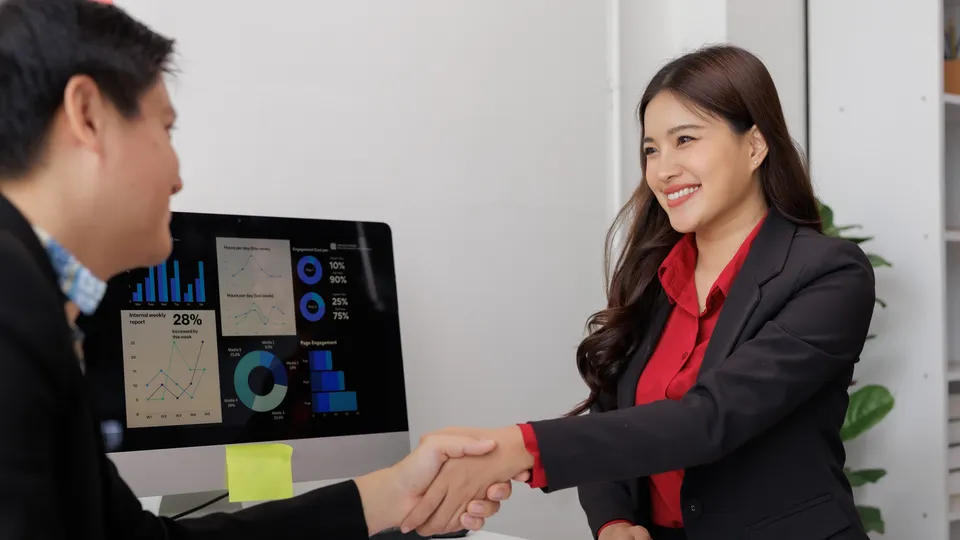 Illustrative photo: Professionals shaking hands during a meeting.