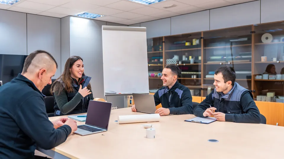 Illustrative photo: Team laughing during a meeting.