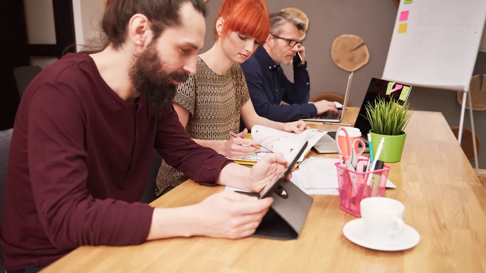 Illustrative photo: Team working together during a meeting.
