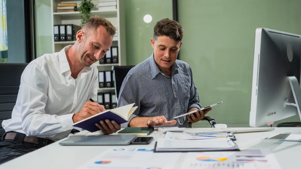 Illustrative photo: Two colleagues working together in an office.