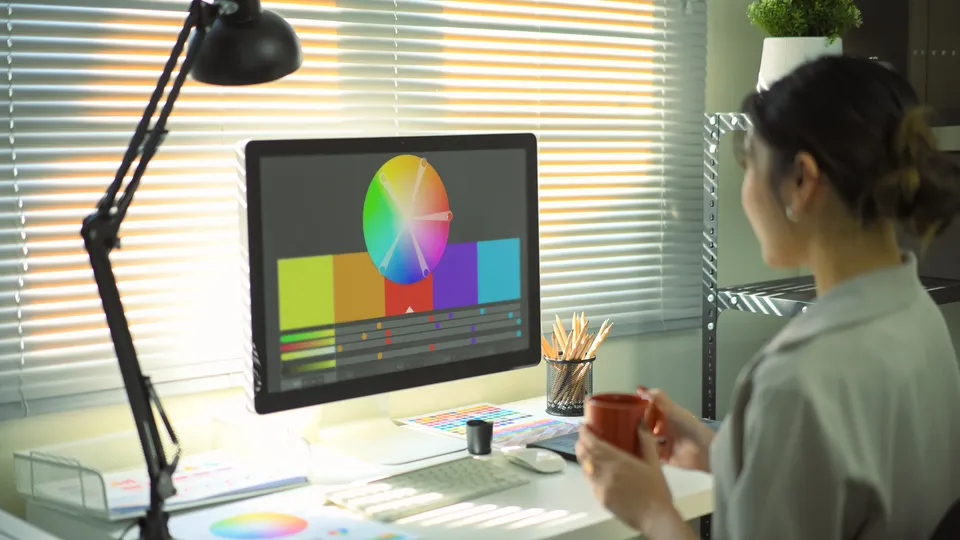 Illustrative photo: Designer working with a colour palette on a monitor.