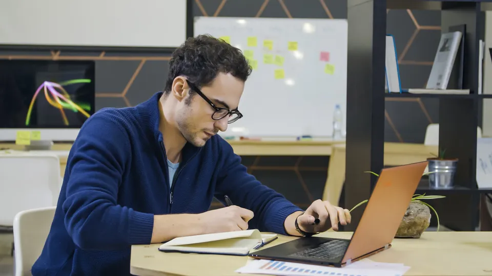 Illustrative photo: Man working at a desk in an office.